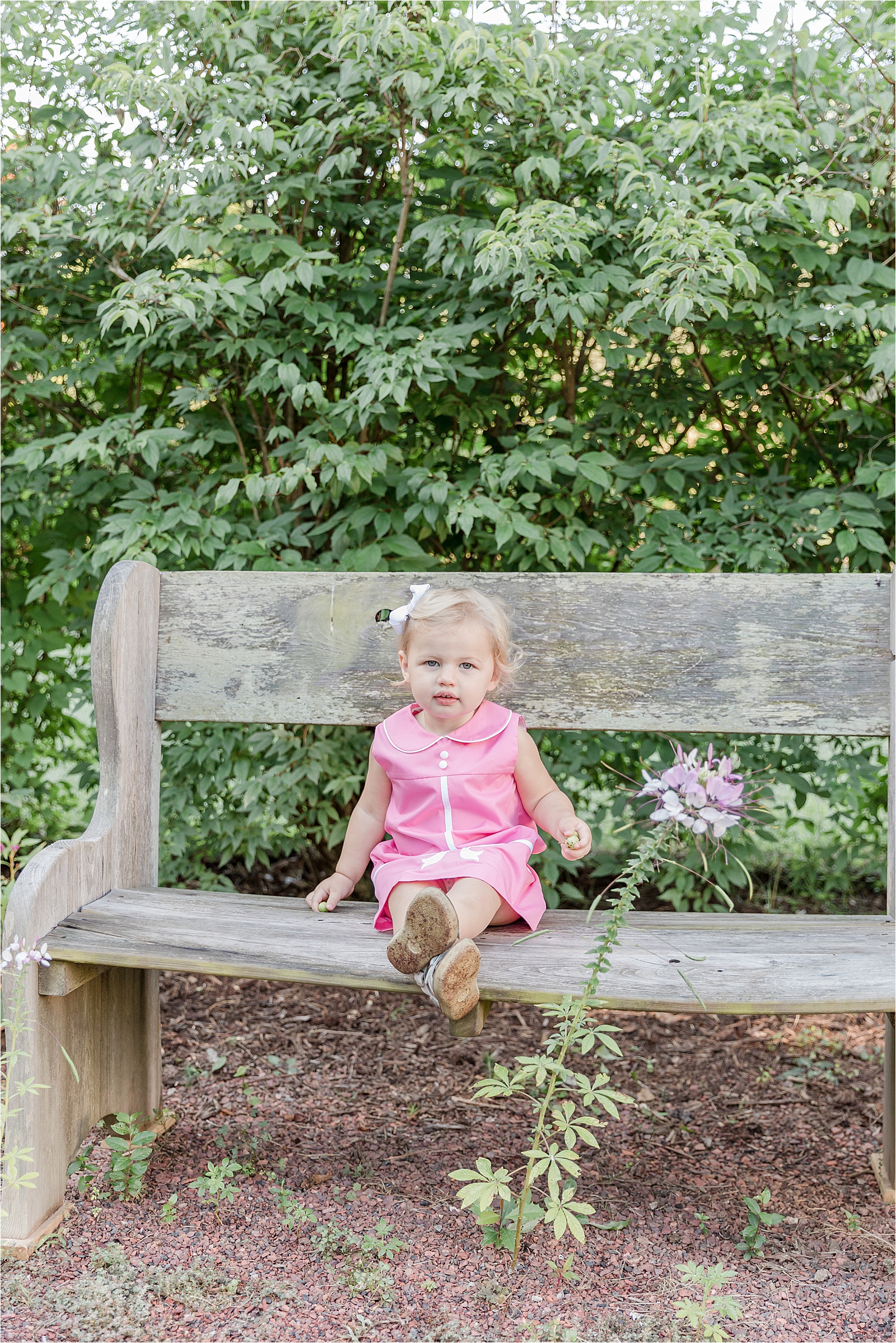 Toddler on bench in garden
