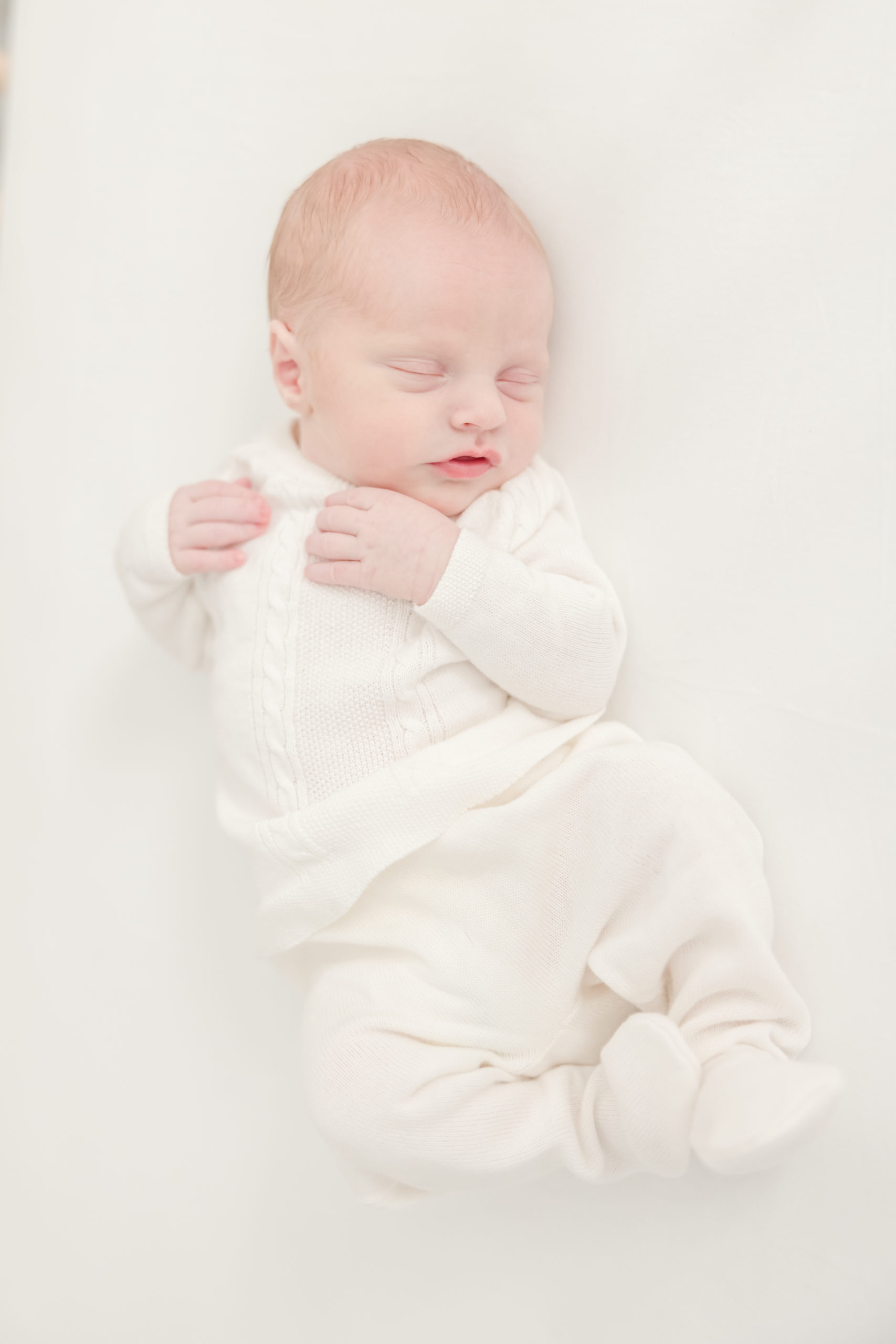 Newborn baby in white sweater