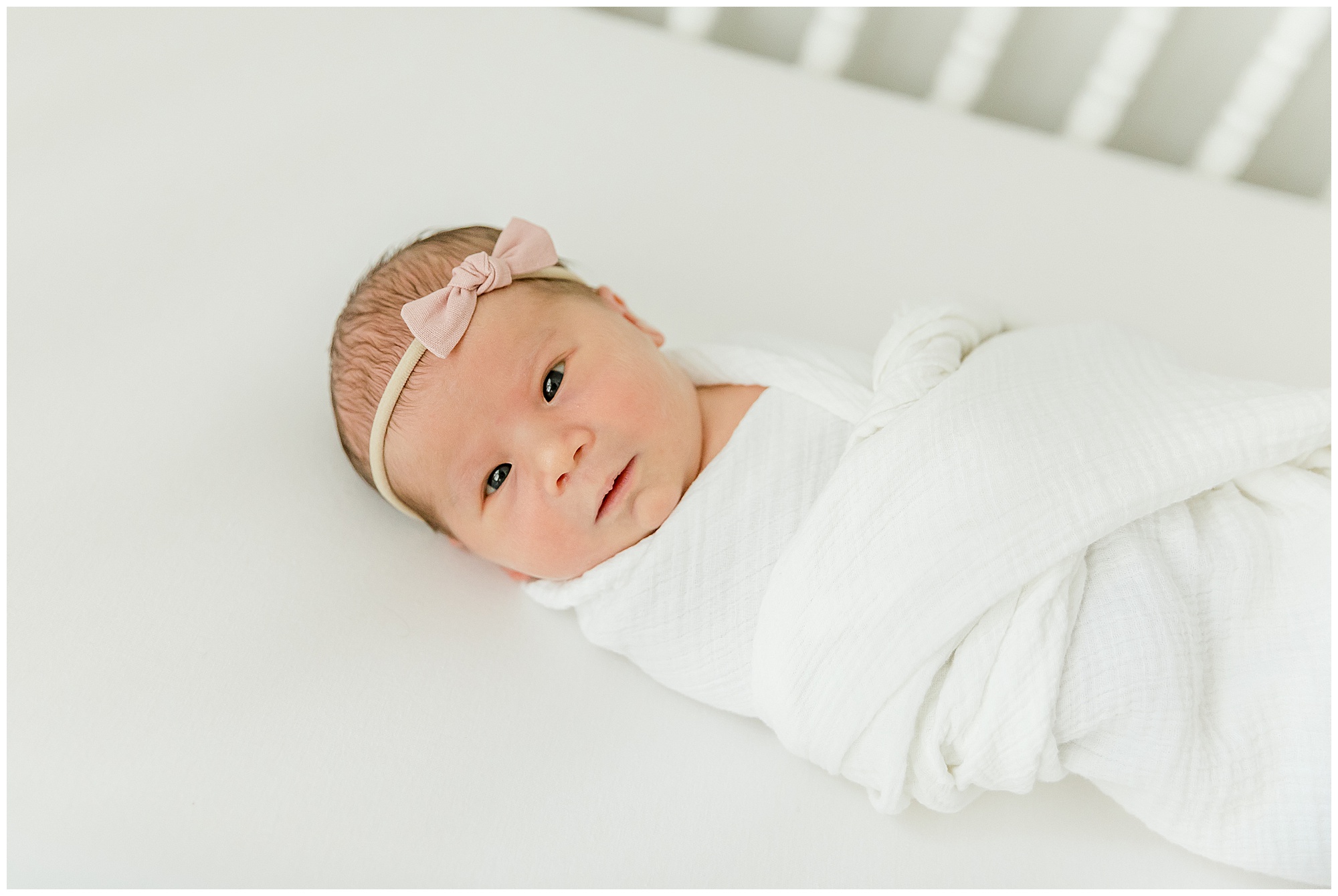 Portrait of newborn baby girl in crib by Greenville SC photographer Molly Hensley.