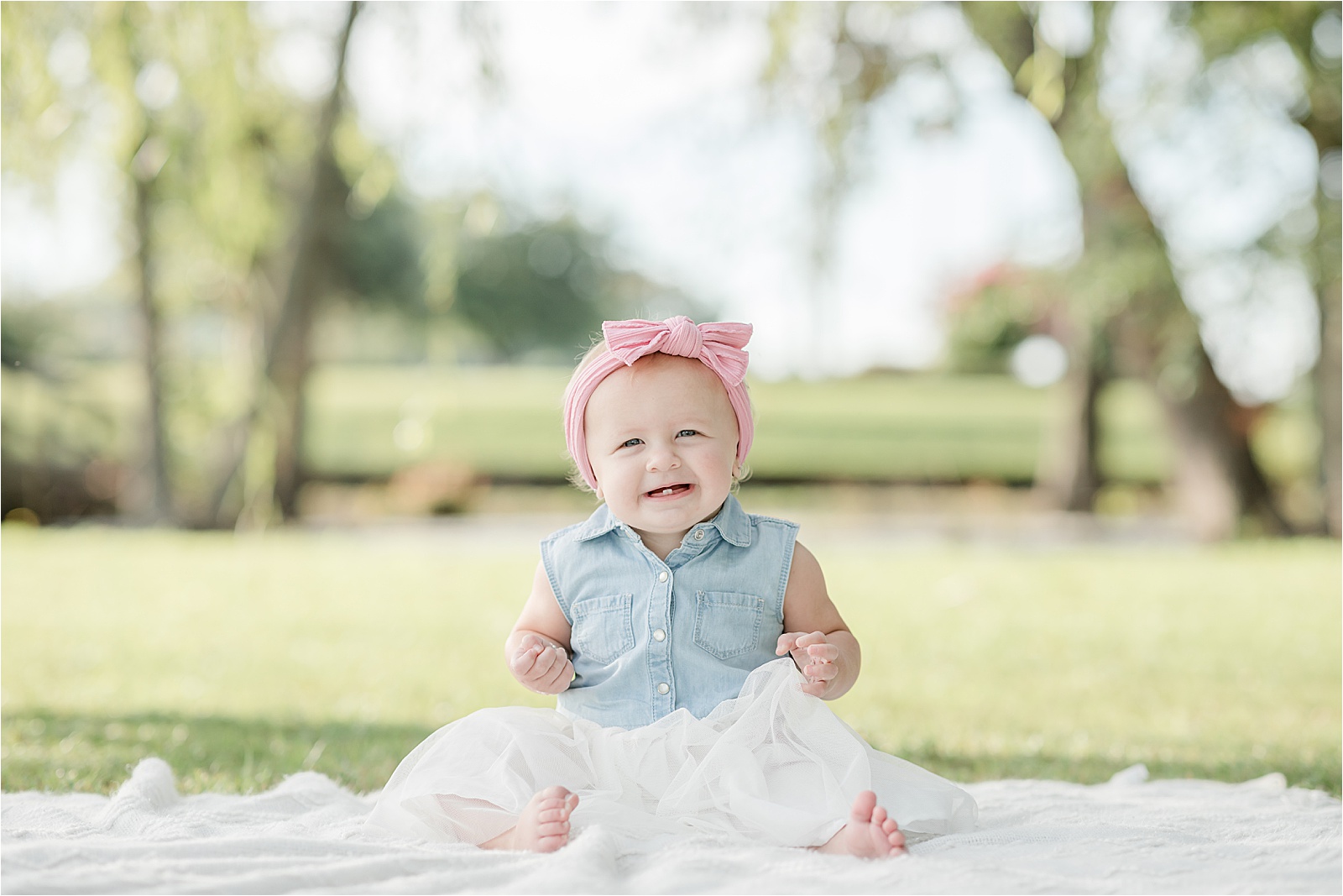 baby girl with pink headband portraits for first birthday