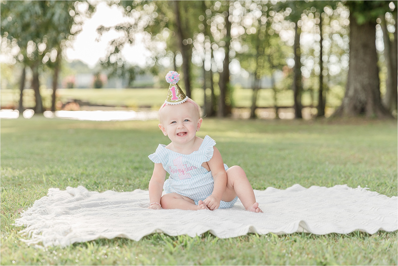 Photo of Baby wearing a sparkly birthday hat by photographer in Greenville SC