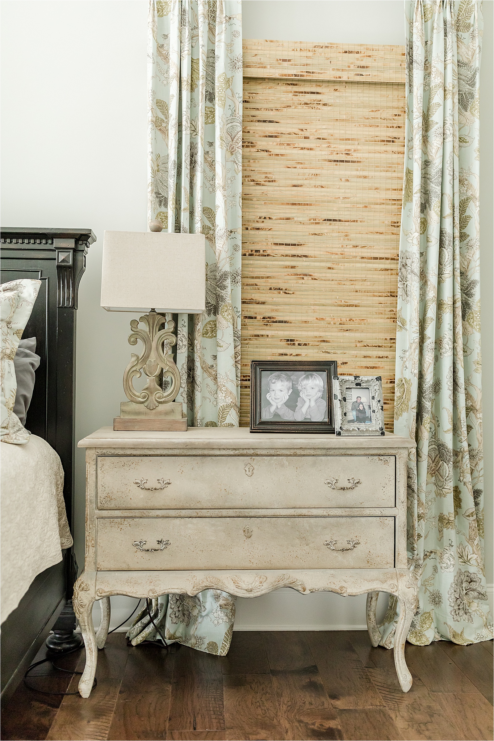 antiqued dresser being used as a nightstand