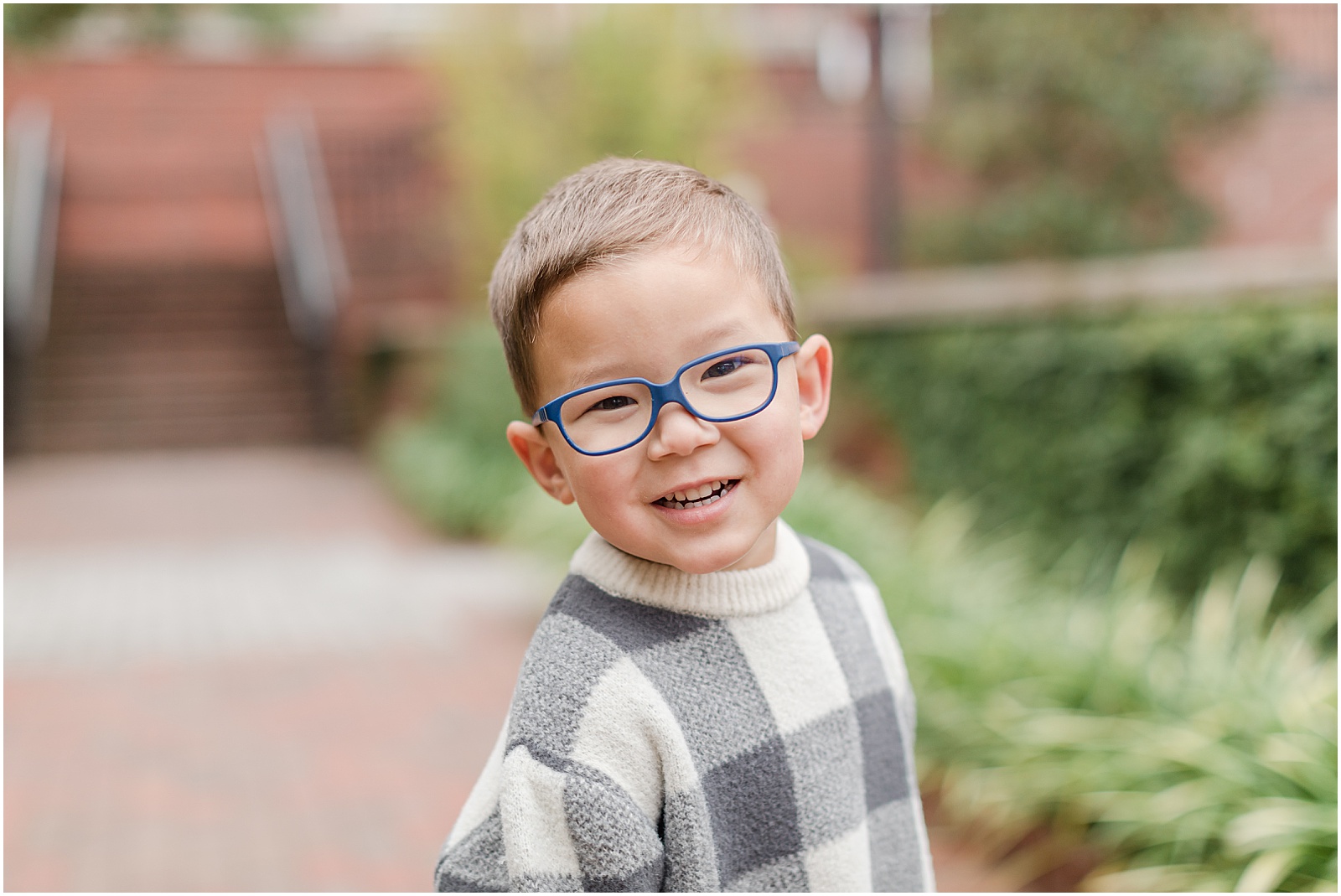 Young goy with blue glasses posing for a portrait in Alpharetta 
