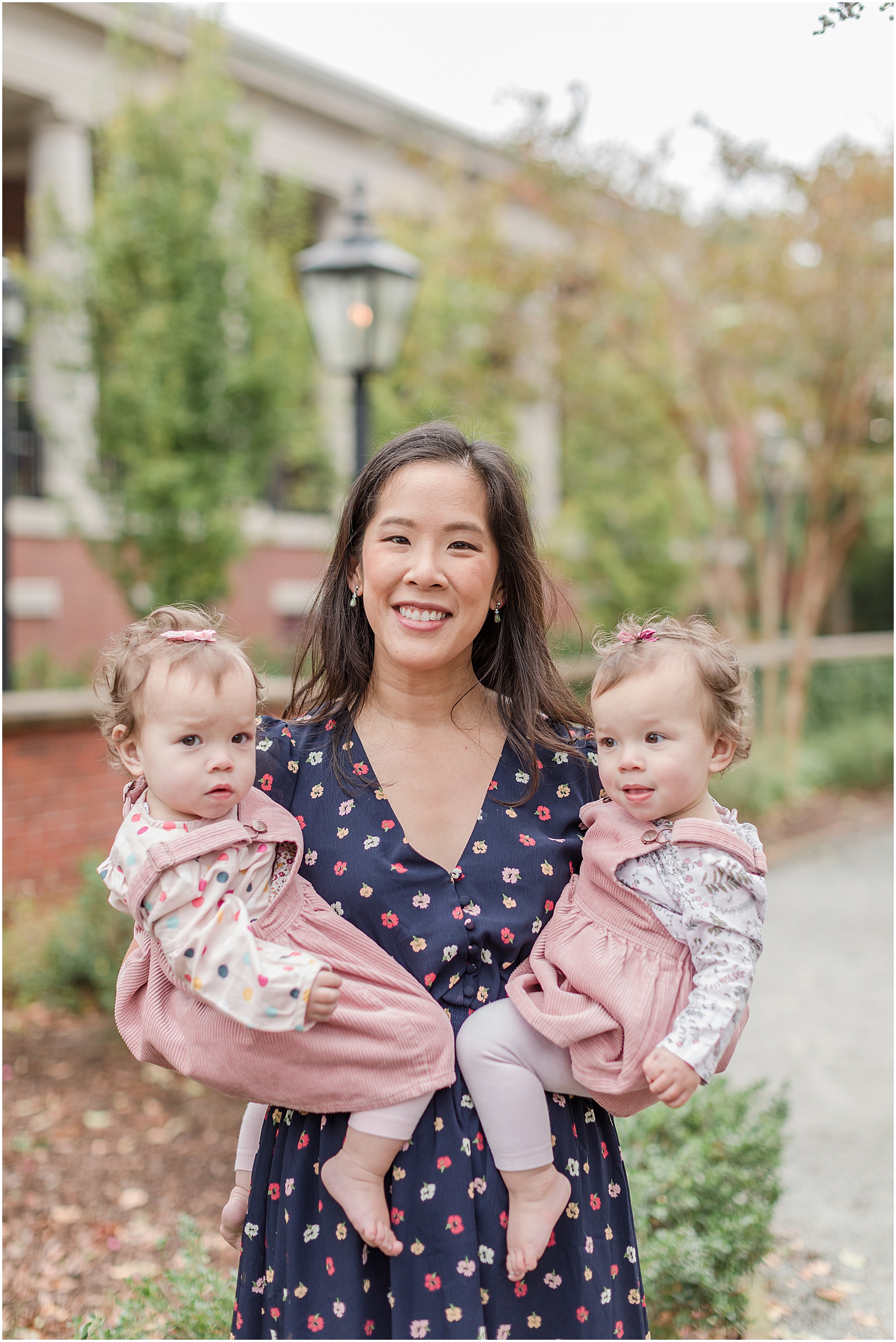 Young mother holding twin girls in Alpharetta Georgia