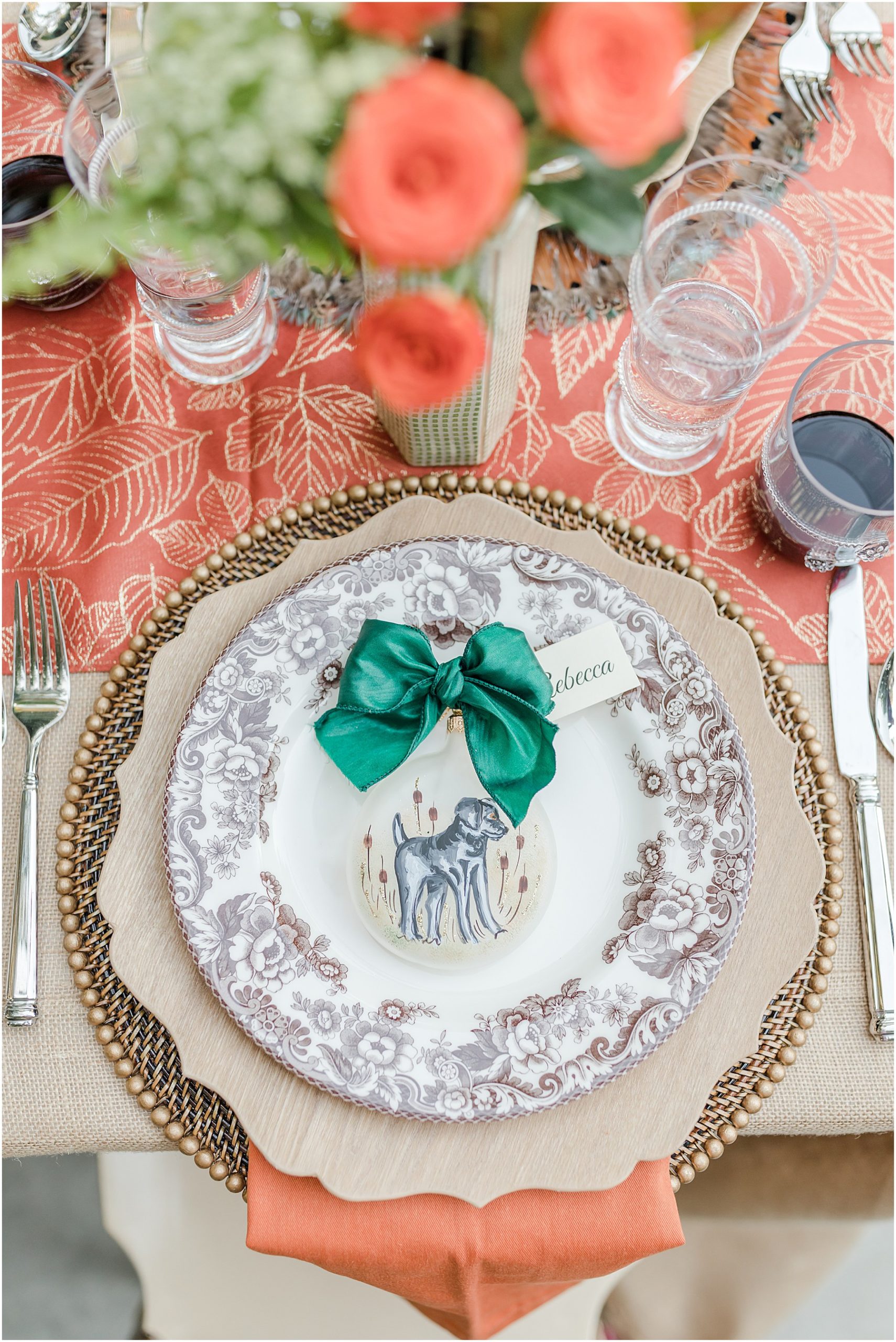 A thanksgiving table place setting featuring a plate with black lab hunting dog.