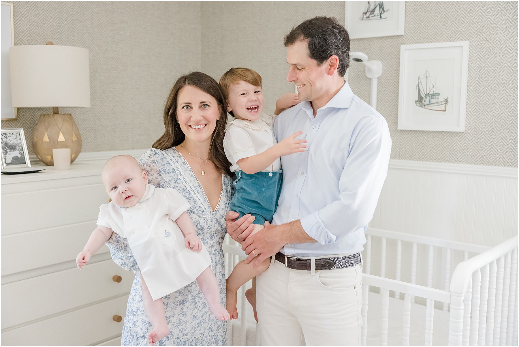 A family posing for a portrait in the nursery of their Greenville Home