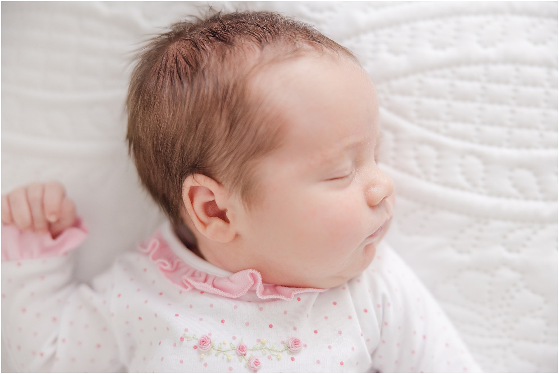 Close up portrait of a baby girl who is alseep.