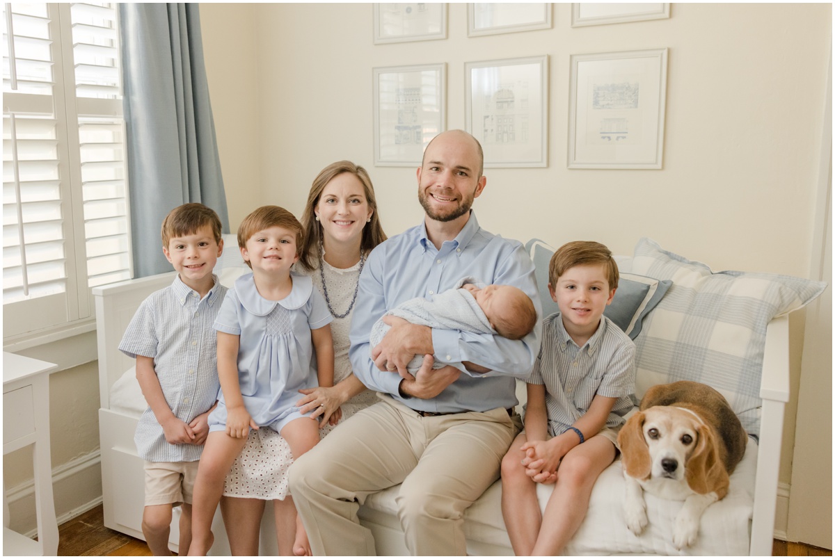 Greenville Newborn Photography portrait of parents with their 4 sons and dog on a daybed.