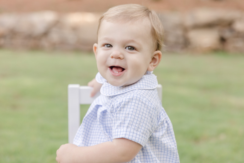 Baby boy smiling over shoulder for portrait