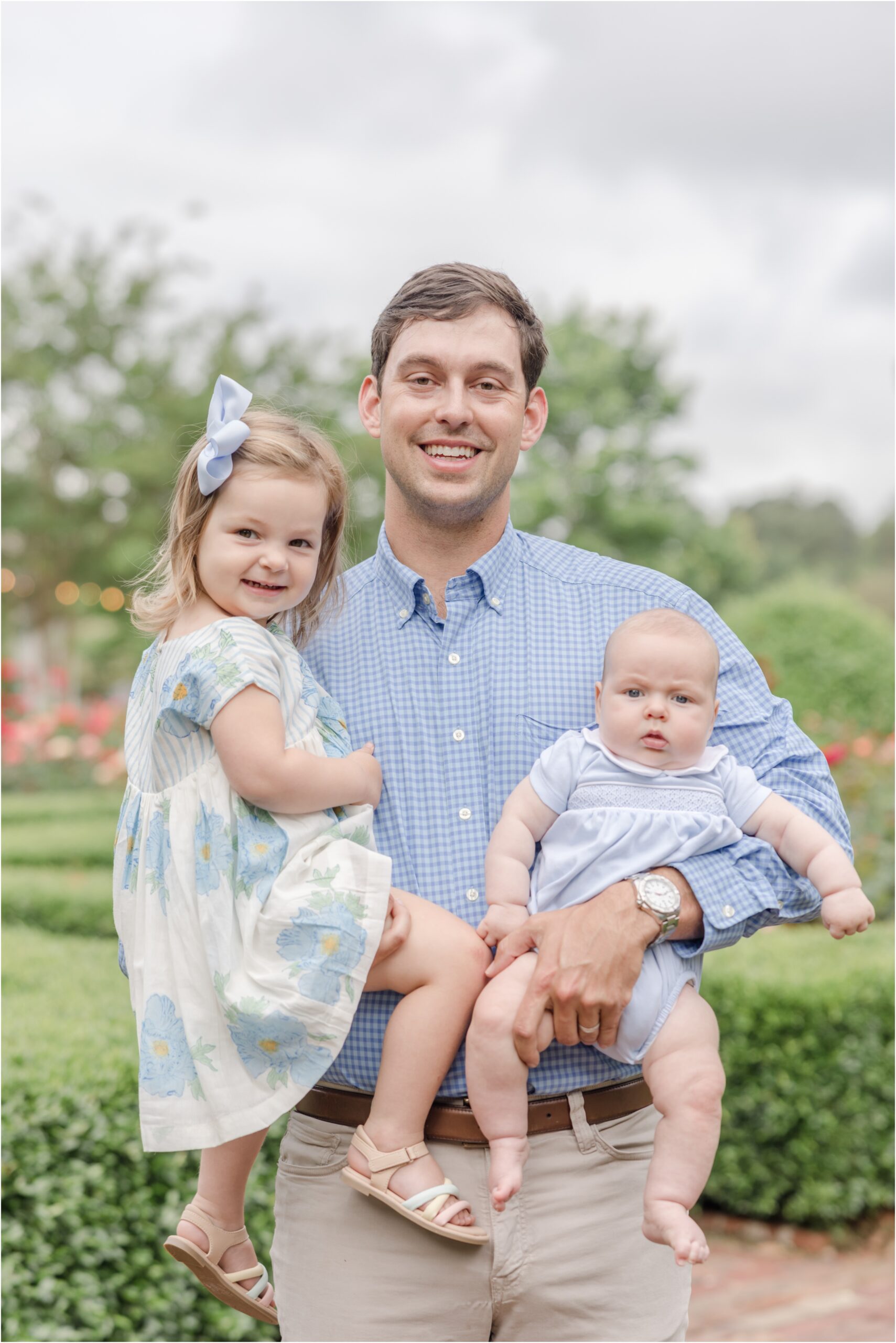 Greenville family photography portraits of a parents with their toddler daughter and baby son in the Janie E Furman Rose Garden.