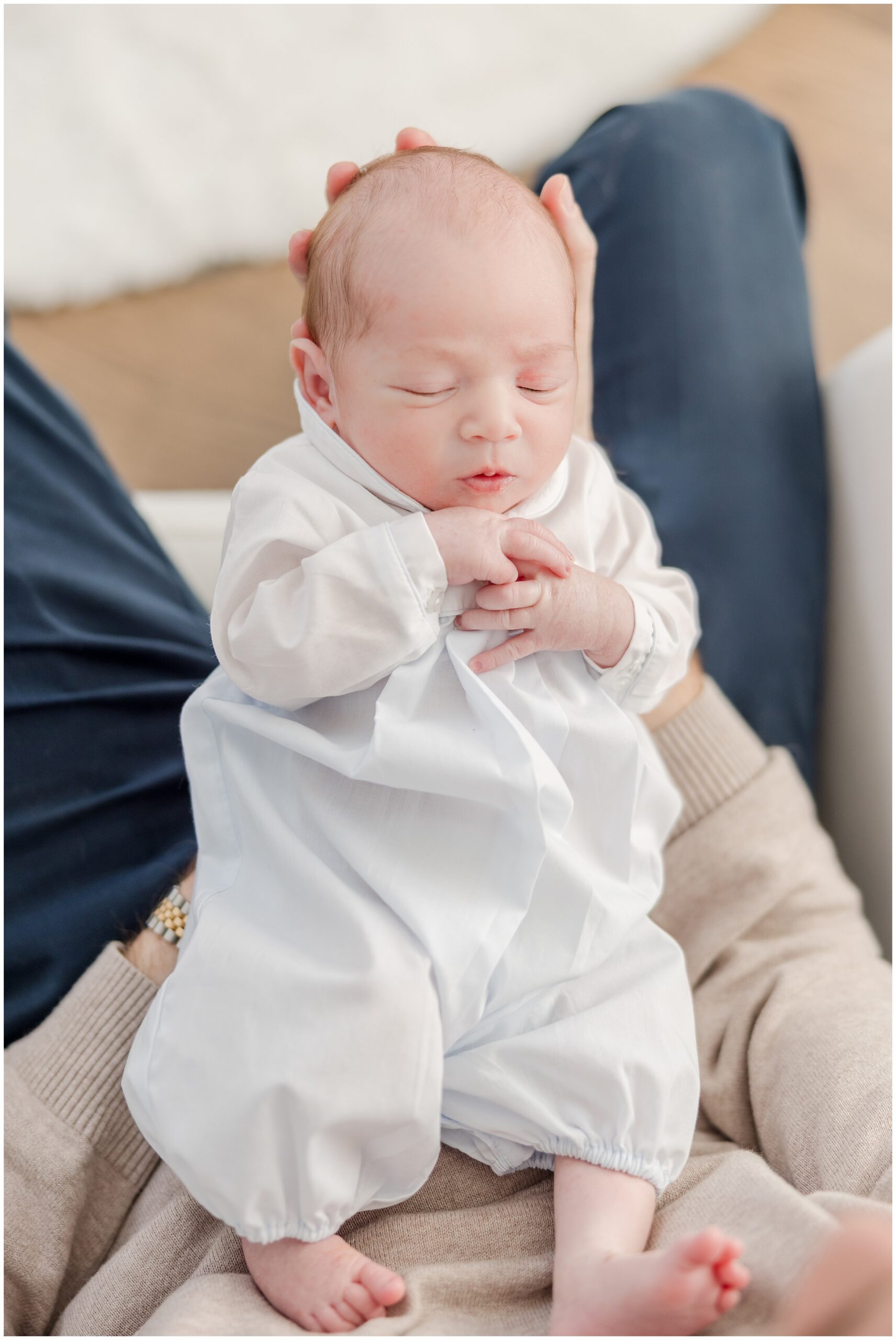 A portrait of a newborn baby boy in his father's hands by Greenville photographer Molly Hensley.